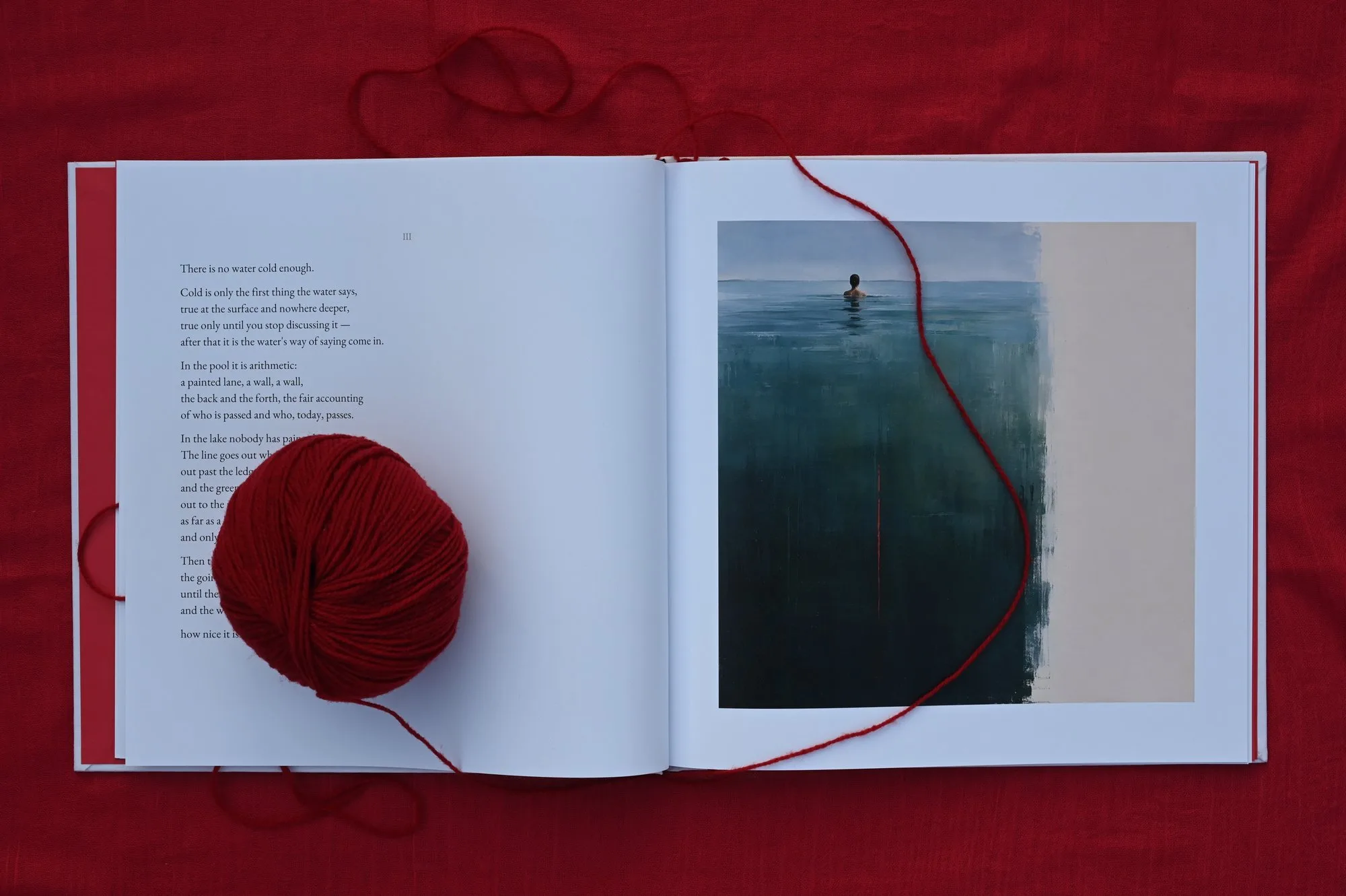 A spread — a poem facing a cool, deep painting of open water, a lone swimmer heading out.
